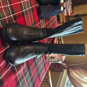 Women’s black boots size 8 1/2 brand new never worn still has paper on one boot.